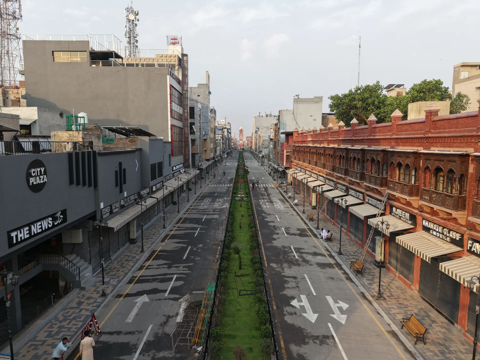Wide empty street in central Faisalabad with the Clock Tower in the distance. Not Wapda City.